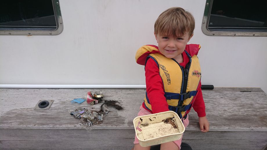 Max with his rubbish gathered from a beach