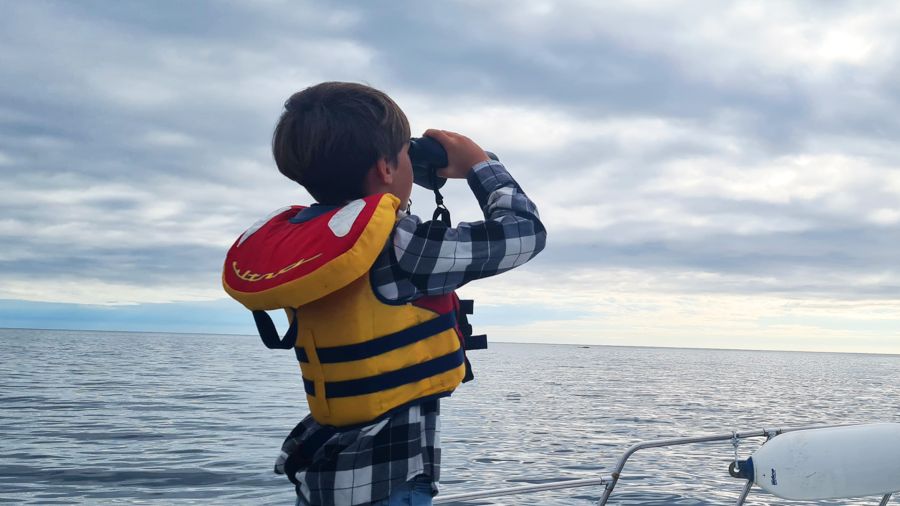 Alex on the bow with binoculars