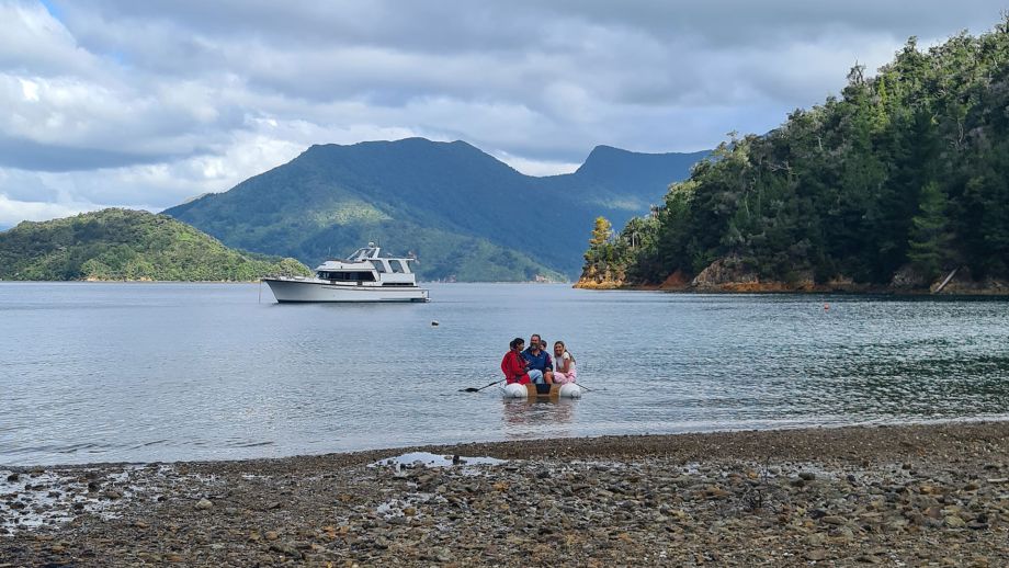 family on dingy rowing to the boat